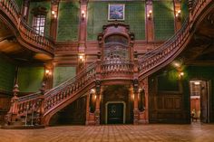 an old building with green walls and wooden stairs