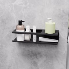 a bathroom shelf with soap and lotion on it