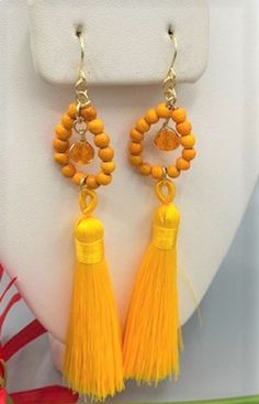 Beautiful long earrings made with a bright yellow tassel one crystal glass bead, 925 sterling silver wire and earrings hook,  and small  orange turquoise beads Made with love and dedication, Feel free to ask for different colors, Orange Tassel Jewelry With Round Beads, Yellow Tassel Drop Earrings With Dangling Beads, Yellow Tassel Earrings With Dangling Beads As Gift, Yellow Dangle Tassel Earrings Gift, Adjustable Orange Tassel Earrings, Orange Tassel Drop Earrings As Gift, Yellow Dangle Jewelry With Tassels, Orange Tassel Drop Earrings, Orange Tassel Drop Earrings For Gift