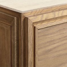 a close up view of the top of a wooden cabinet with wood grained edges