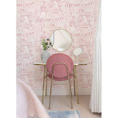 a pink chair sitting in front of a mirror on top of a wooden table next to a window