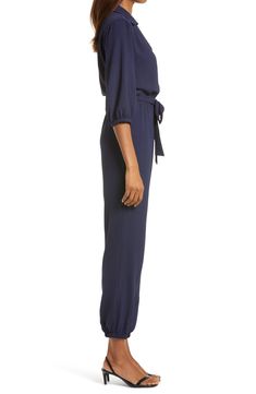 The jumpsuit trend is, well, hopping, and this option, styled with an easy tied waist and elastic cuffs, is a winning way to wear the look. 58" length; 30" inseam; 10" leg opening (size Medium) Front button-and-loop closure Surplice V-neck with spread collar Long sleeves Elastic cuffs and waist Front slant pockets Removable tie belt Partially lined 100% polyester Hand wash, line dry Made in the USA Women's Clothing Chic Jumpsuit With Elastic Waistband For Loungewear, Spring Relaxed Fit Jumpsuits And Rompers With Drawstring, Chic Loungewear Jumpsuits With Elastic Waistband, Chic Jumpsuits And Rompers With Elastic Waistband For Loungewear, Chic Loungewear Jumpsuits And Rompers With Elastic Waistband, Chic Jumpsuits With Tie Waist And Relaxed Fit, Chic Overalls Jumpsuit With Elastic Waistband, Workwear Jumpsuit With Tie Waist And Relaxed Fit, Chic Relaxed Fit Jumpsuits And Rompers With Tie Waist