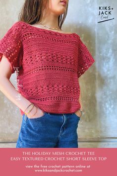 a woman standing in front of a wall wearing a red crochet top