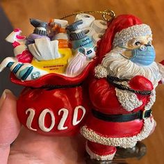 a santa clause ornament is hanging from a keychain in someone's hand