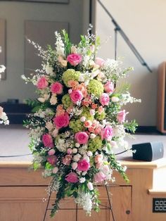 a bunch of flowers that are sitting on a stand