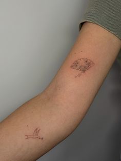 a person with a small tattoo on their arm