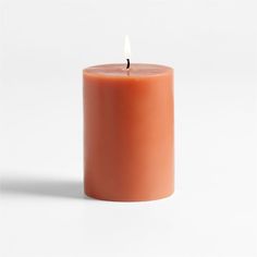 an orange candle with a white background