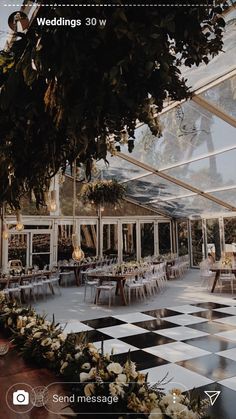 the inside of a wedding venue with tables and chairs