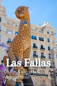 a large statue of a leopard in front of a building with the words las fallas written above it