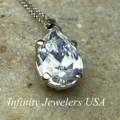 "The pendant pictured is a simulated diamond #6998 Also available with moissanite - please message us for pricing. -Approximate total carat weight: approx. 3.60ctw diamond equivalent -Center Stone Size: 12x8mm - approx. 3.60ct diamond equivalent -Center Stone Shape: pear / tear drop -Gem Type: simulated diamond -Stone Clarity: VVS1 -Stone Color: D -Moh's Scale: 8.5 hardness -Metal Type and Purity: 14k white gold -Setting: 5 prong basket head -Chain: delicate 14k gold chain / heavier option with Classic Brilliant Cut Drop Necklace For Formal Occasions, Classic Teardrop Drop Necklace For Anniversary, Formal Pear-shaped Solitaire Necklace, Teardrop Solitaire Jewelry For Anniversary, Classic Teardrop Necklace For Anniversary, Classic Pear-shaped Drop Necklace With Brilliant Cut, Classic Teardrop Pendant Drop Necklace With Brilliant Cut, Teardrop Anniversary Drop Necklace In Fine Jewelry Style, Formal Drop Necklace With Brilliant Cut Cubic Zirconia