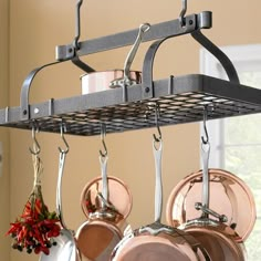 pots and pans are hanging from a rack