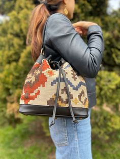 Thank you for visiting our shop!  It's very useful bag as shoulder and as crossbody bag.  This bag is spacious and holds a lot of things. Size         : 30cm x 27cm x 8cm Material  : wool / leather We select beautiful vintage kilims from all over the anatolian area and middle east area. and We do special wash for Kilim rug first, after that cut the kilim to remake unique kilim bags at our atelier  one by one. All products have been produced in a smoke-free environment.  Vintage kilim with colore Everyday Bucket Hobo Bag With Detachable Strap, Everyday Use Hobo Bag With Detachable Strap, Everyday Hobo Bag With Detachable Handle In Bucket Shape, Multicolor Leather Bucket Bag With Detachable Strap, Travel Shoulder Bag With Detachable Handle In Bucket Shape, Travel Bucket Shoulder Bag With Detachable Handle, Multicolor Bucket Bag With Dust Bag, Travel Bucket Shoulder Bag With Detachable Strap, Travel Bucket Shoulder Bag With Leather Handles