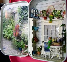 an open book with pictures and plants on the inside, sitting on a pink plate