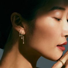 An Asian woman with her hair pulled away wears a cascade of diamond earrings. The dramatic shadow that casts just above her brow gives the photo an old hollywood kind of drama. Personalized Gold Bracelet, Catbird Jewelry, Pearl And Diamond Earrings, Tennis Necklace, Swan Lake, Gold Bracelet Chain, Tennis Bracelet Diamond, Diamond Drops, Diamond Drop Earrings