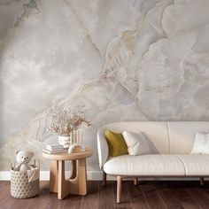 a white couch sitting next to a wooden table on top of a hard wood floor