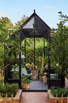 an outdoor garden with lots of potted plants