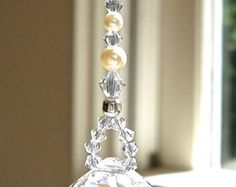 a crystal ornament hanging from a window sill