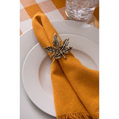 an orange napkin on top of a white plate