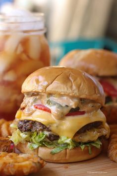 a cheeseburger and onion rings on a cutting board