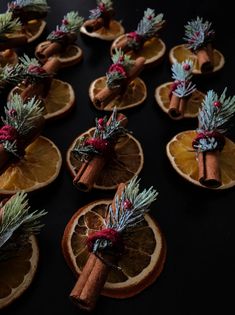 orange slices decorated with cinnamon sticks and pine cones are arranged on top of each other