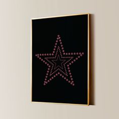 a star with pink dots is mounted on a wall