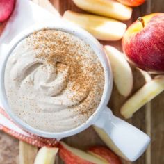 an apple and cinnamon dip with apples around it