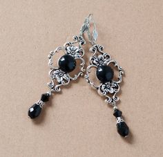 These elegant earrings are made from round black agate stone set in antique silver filigree setting, embellished with black waterdrop beads at the bottom. They will make a beautiful accessory for someone who loves Victorian or vintage style. -The earrings are 2.5 inches long, without the lever back closure and an inch wide at the widest part of the filigree setting -They have a lever back closure (lead and nickel free) SHIPPING: Default shipping is by regular mail, which does not have tracking, Black Dangling Earrings, Black Silver Earrings, Elegant Black Oxidized Finish Earrings, Black Elegant Chandelier Earrings, Nickel Free, Elegant Black Filigree Earrings, Black Filigree Dangle Jewelry, Formal Black Filigree Earrings, Black Nickel-free Earrings For Wedding, Nickel-free Black Earrings For Wedding