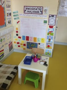 a child's desk and chair in a room with bulletin boards on the wall