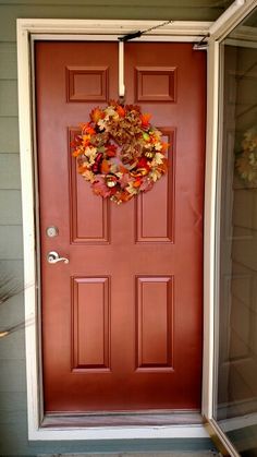 a red front door with a wreath on it