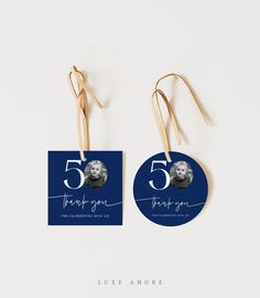 two tags with the number five on them are hanging from gold earwires against a white background