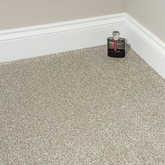 an empty room with a black and red object on the floor in front of it