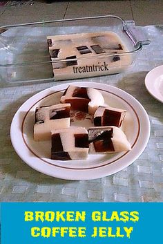 broken glass coffee jelly is sitting on a table next to a plate with pieces of chocolate