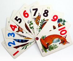 four playing cards with numbers and animals on them