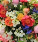 a bunch of flowers that are sitting in a vase on a table with other flowers