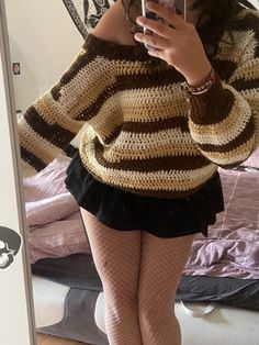 a woman is taking a selfie in the mirror while wearing fishnet tights