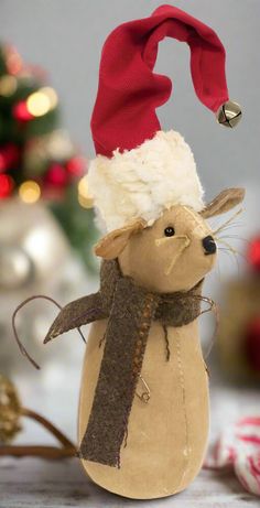 a stuffed animal wearing a santa hat and scarf