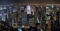 an aerial view of new york city at night from the top of the empire building