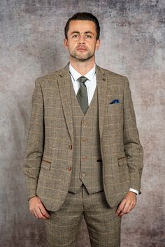 As worn by West Ham United goalkeeper Lukasz Fabianski! This Ted suit offers a sophisticated take on English gent-style, crafted with a traditional herringbone wool-mix cloth in earth-toned hues. The multi-tonal check pattern invokes 19th century tweed yet the contemporary colour accents make it ideal for any 21st century wardrobe. Matching children's suit available. Features Herringbone Slim fit Single-breasted Notch lapel Single back vent Four button cuff Double button blazer fastening Complim Timeless Tweed Suit With Welt Pockets, Tweed Three-piece Suit With Notch Lapel For Work, Winter Tweed Three-piece Suit For Work, Winter Tweed Three-piece Business Suit, Timeless Tweed Jacket With Welt Pockets, Winter Business Tweed Three-piece Suit, Winter Tweed Three-piece Suit For Business, Tailored Herringbone Tweed Jacket In Timeless Style, Tailored Tweed Three-piece Suit