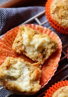 some muffins are sitting on top of an orange paper cupcake liner holder