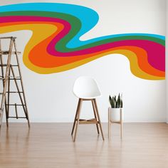 a room with a chair, ladders and a wall painted in bright colors that has wavy lines on it