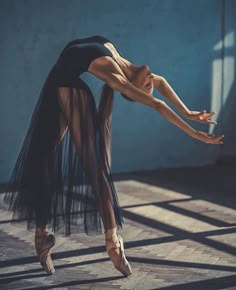 a ballerina is posing for the camera with her arms stretched out and legs bent