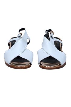 Step into summer with these stylish Robert Clergerie white leather sandals accented with reflective rose gold heels and trim. A versatile staple for any wardrobe, pair it with linen crop pants and a knit top for a chic summer look. Size 8 (FR 38.5) Made in France Leather upper Buckle ankle closure Rose gold trim and heel Heel height 2" White Slingback Sandals With Heel Strap For Spring, Modern White Sandals With Contrasting Heel Counter, Modern White Sandals With Contrasting Heel, White Leather Sole Heels For Summer, Luxury Ankle Strap Slingback Sandals For Summer, White Leather Slingback Sandals For Spring, White Slingback Sandals With Removable Insole For Summer, Summer Slingback Sandals With Contrasting Heel, White Slingback Sandals For Spring