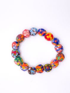 This beaded bracelet is made of Ghanaian Krobo glass beads, the orange, dark blue, green, red, yellow, and sky blue colors of the beads pair well with any outfit. The bracelet is stretchy and fits most wrists. Each bracelet is uniquely designed, therefore, color and style may vary slightly from the bracelet pictured.  Bead diameter: 1/2" (12.7mm) Bracelet length: 10" (254mm) Approx. number of beads per bracelet: 18 Hand-strung Multicolor Bracelets For Friendship, Multicolor Wooden Beaded Bracelets, Multicolor Beaded Bracelets With Oval Beads, Colorful Vibrant Beaded Bracelets With Round Beads, Vibrant Colorful Beaded Bracelets With Round Beads, Colorful Vibrant Beaded Bracelets, Colorful Adjustable Beaded Bracelets With Large Beads, Multicolor Beaded Bracelets With Large Beads, Multicolor Bracelets With Large Round Beads