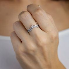 a woman's hand with a diamond ring on it