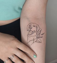 a woman's arm with a dog tattoo on the left side of her body