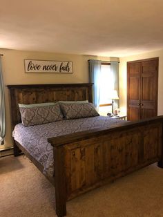 a bedroom with a large bed and wooden headboard