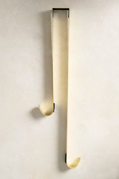 a white wall with two hooks on it