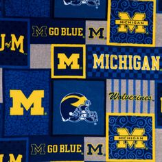 the michigan wolverines are all over this blue and yellow quilted blanket that is on display