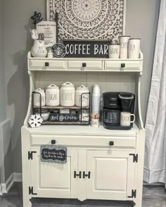 an old fashioned coffee bar is decorated with white and black accents, such as mugs