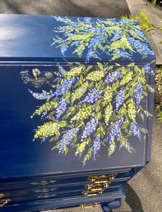 a blue box with flowers painted on it